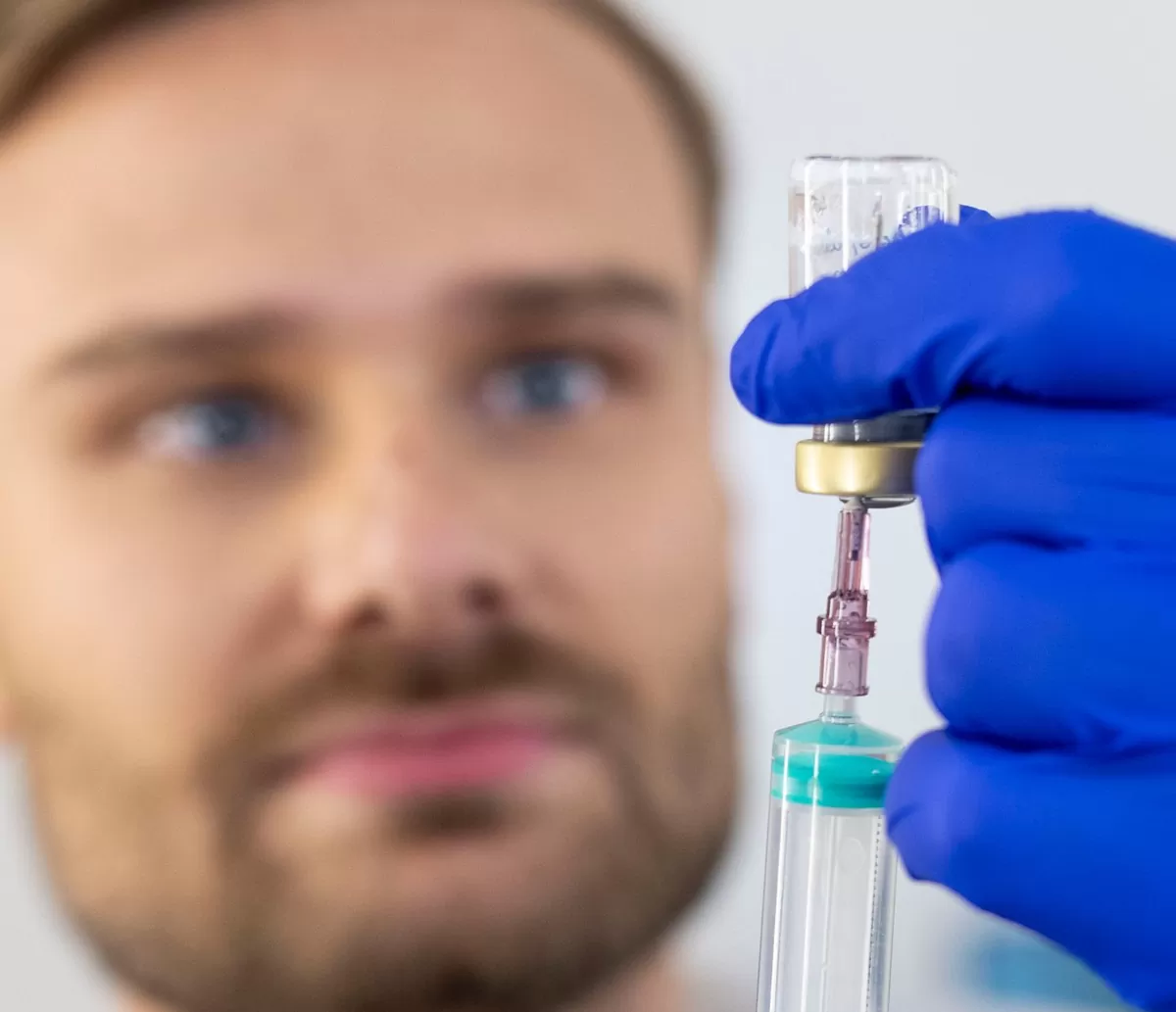 Clinician preparing a syringe from a vial