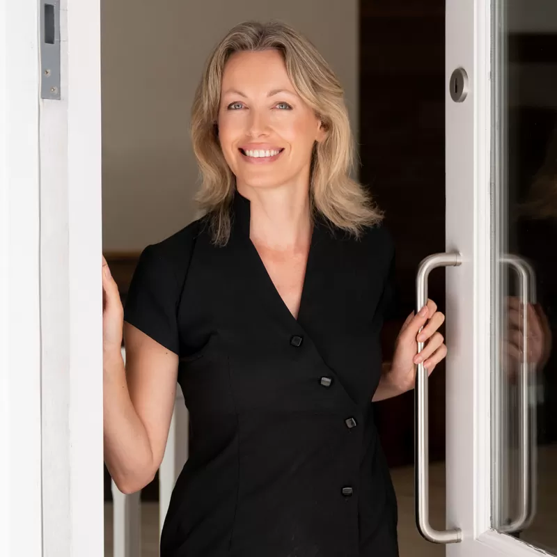 Smiling clinic owner at the clinic door